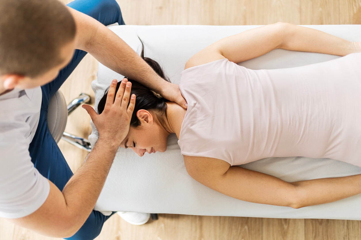 Chiropractor performing neck adjustment on female patient in chiropractic care session at Active Life Chiropractic.