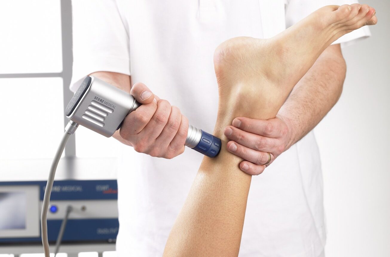 Shockwave therapy device applied to patient's ankle for pain relief and healing at Active Life Chiropractic.