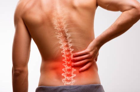 Person experiencing back pain, highlighting the spine with a red glow, emphasizing chiropractic care for back pain relief.